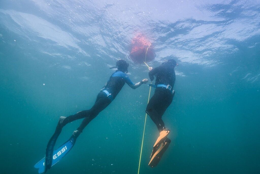 Two freedivers during their ascent from the depths