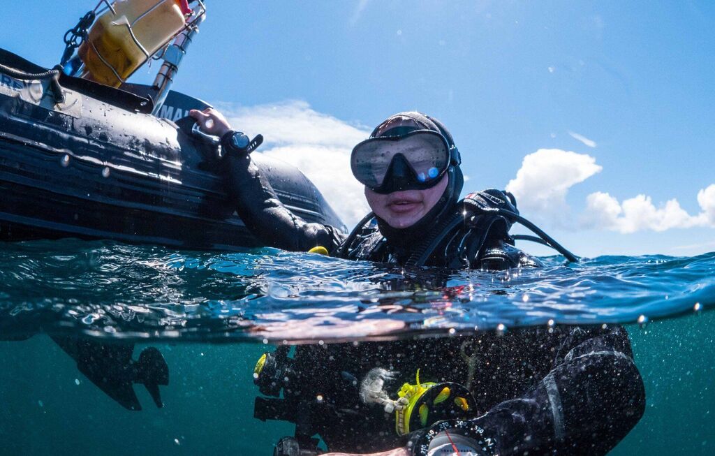 diver holding boat before scuba diving in the Atlantic near aran islands