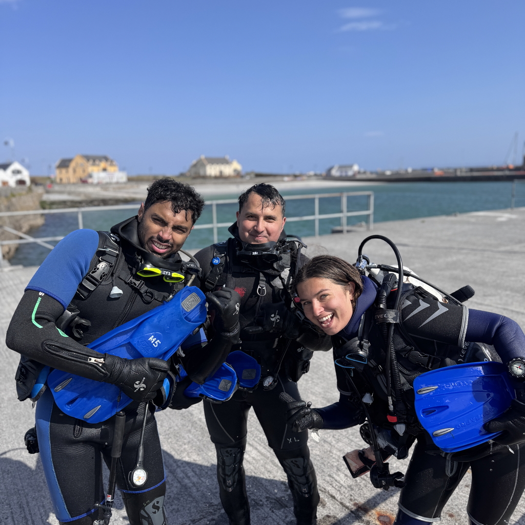 Three students celebrating after their first try scuba diving