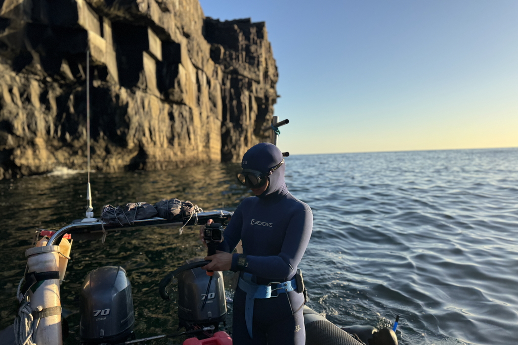 Advanced freediver getting ready for a dive from the boat close to Inishmore, Aran Islands
