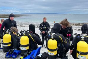 divers group during briefing on the beach before go scuba dive in Inishmore, aran islands
